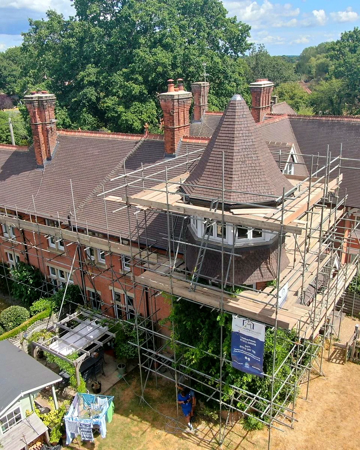 House with the scaffold up and the roof stripped back during an urgent repair