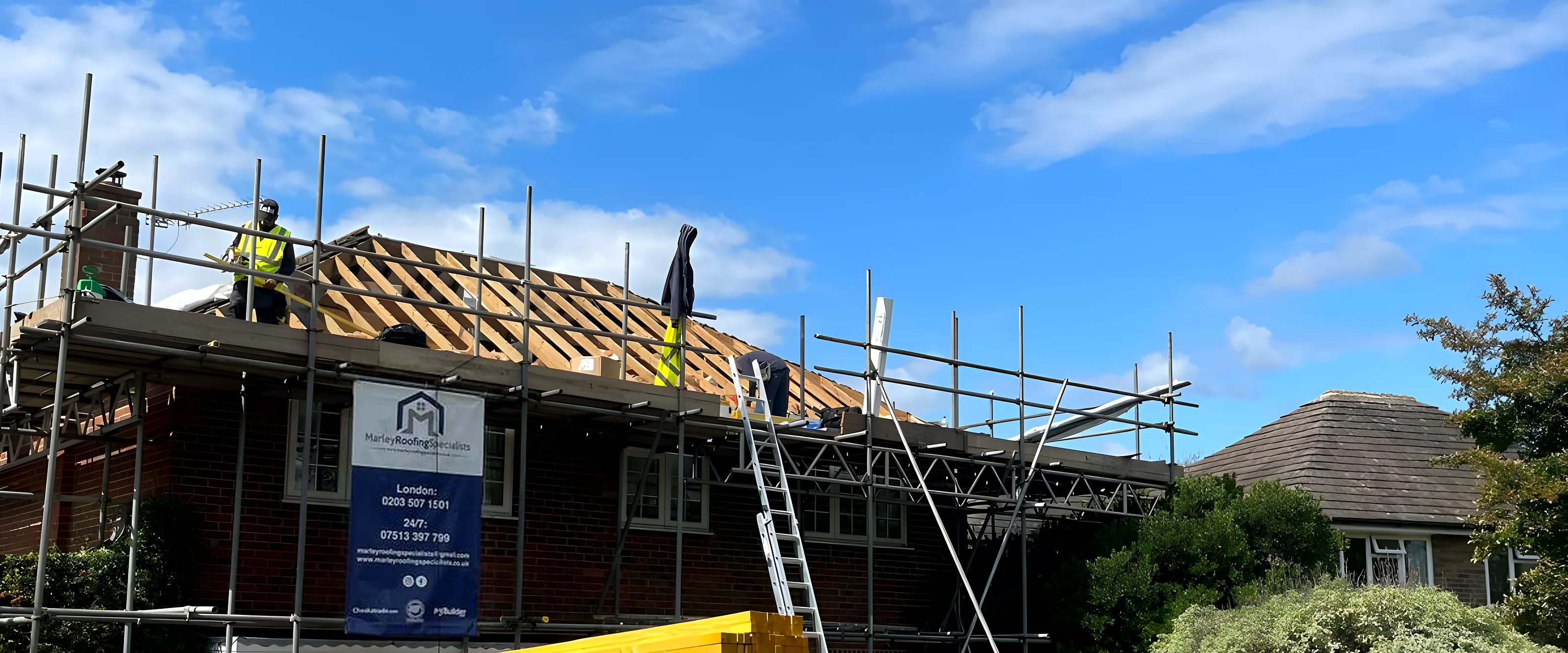 House with the scaffold up and the roof stripped back, mid re roof