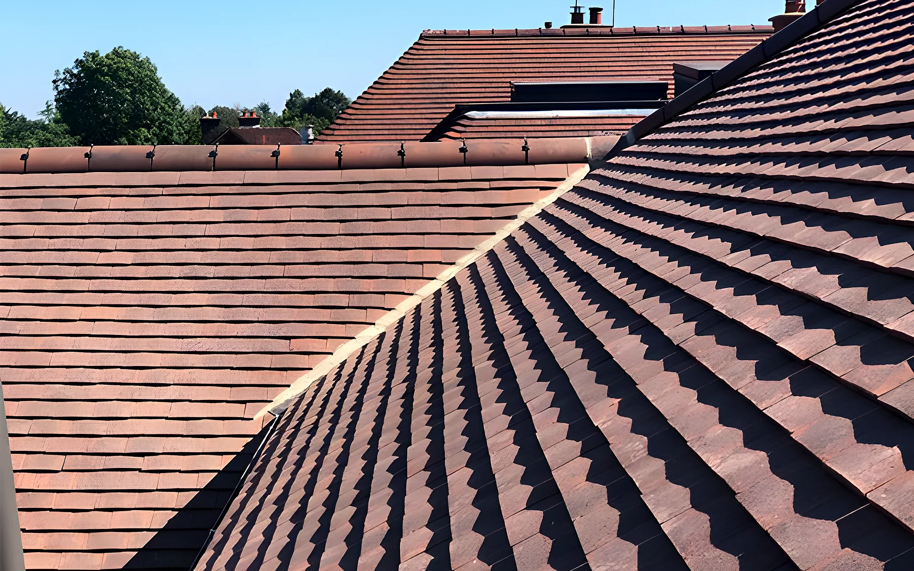 A clay tiled roof with a lead valley