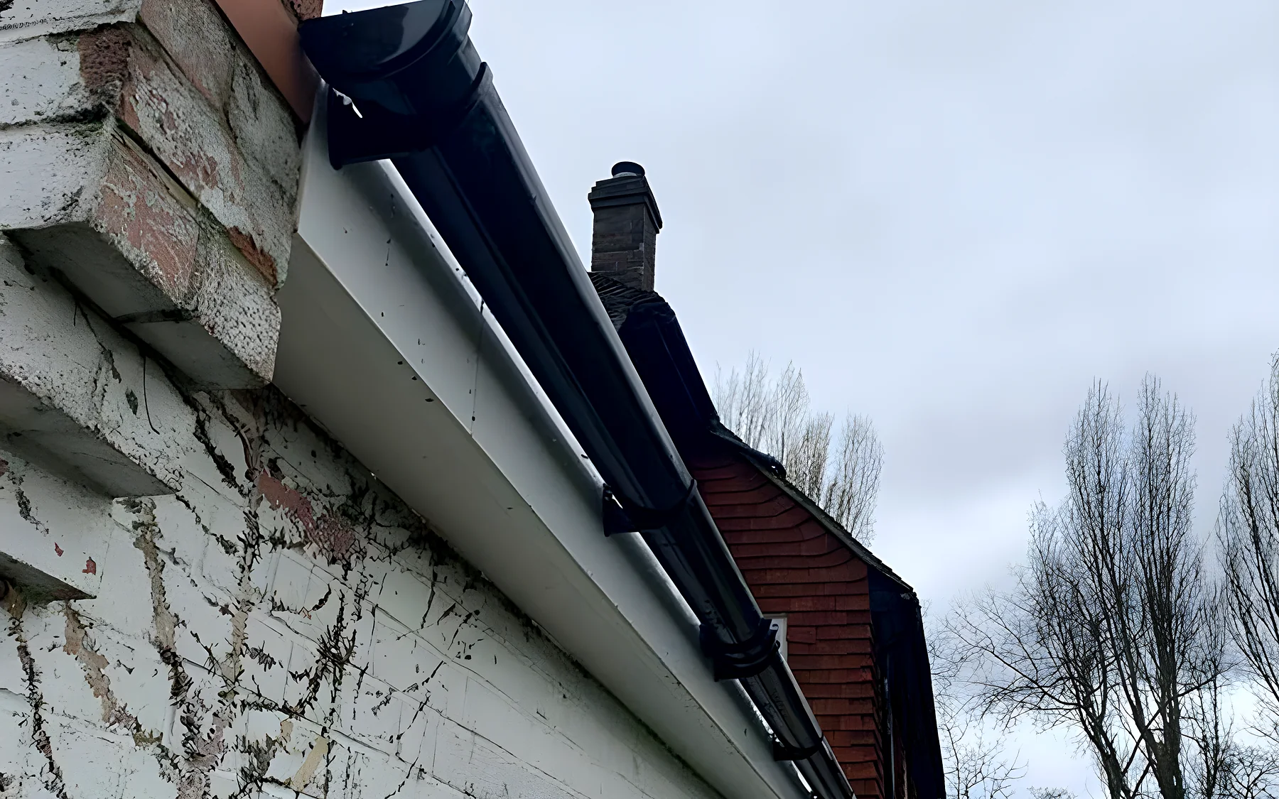 A rotten timber soffit before replacement
