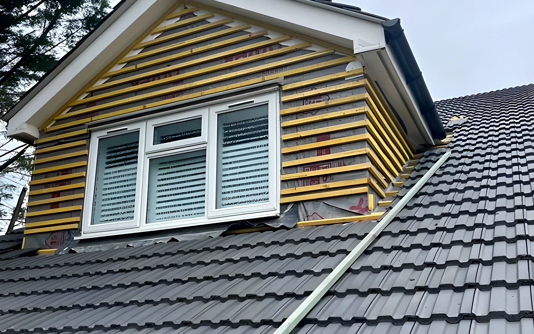 A dormer with new tiles and cladding