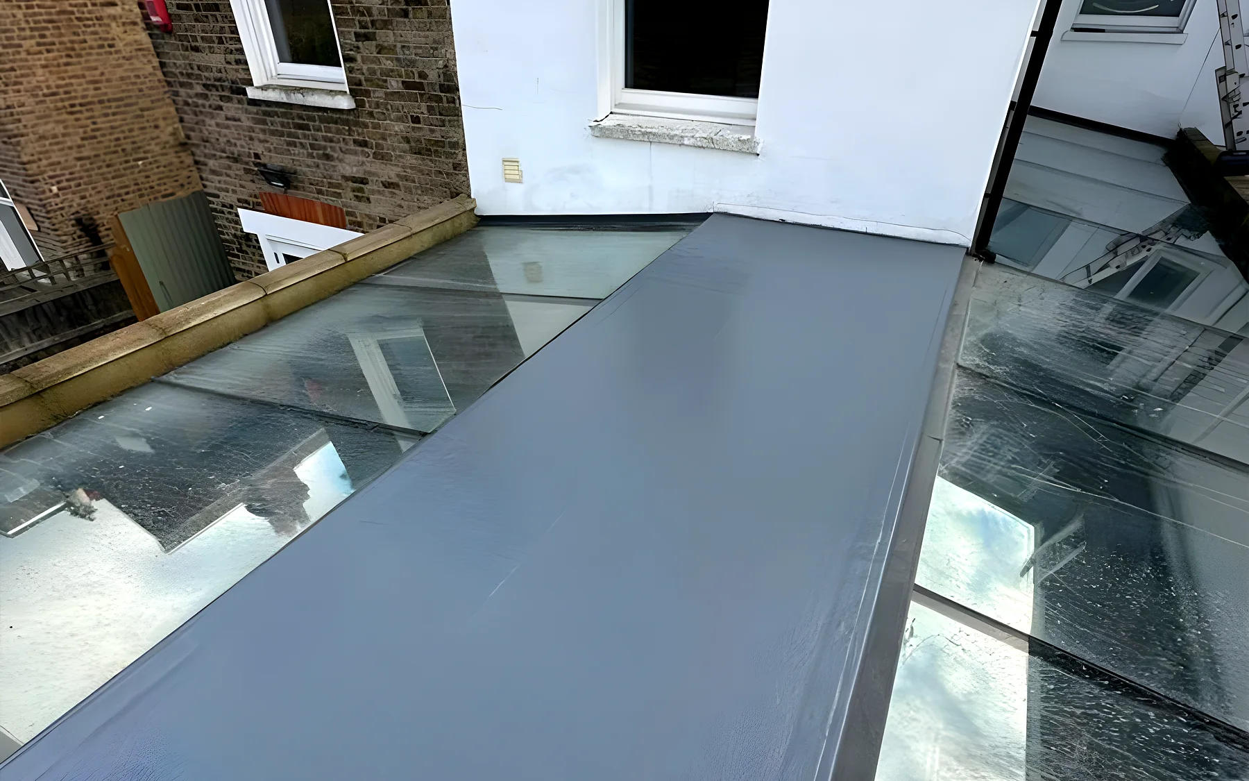 A GRP fibreglass flat roof with a rooflight, finished in grey