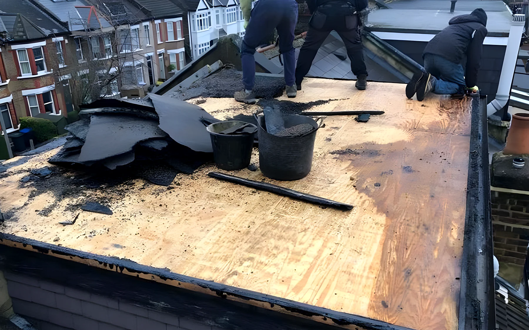 Our roofers laying a new flat roof deck on a terraced house