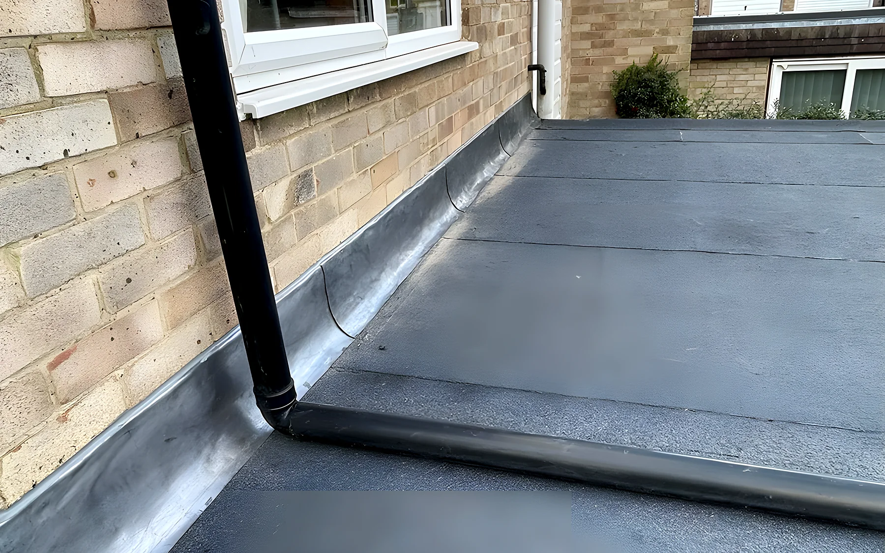 A finished flat roof in grey mineral felt