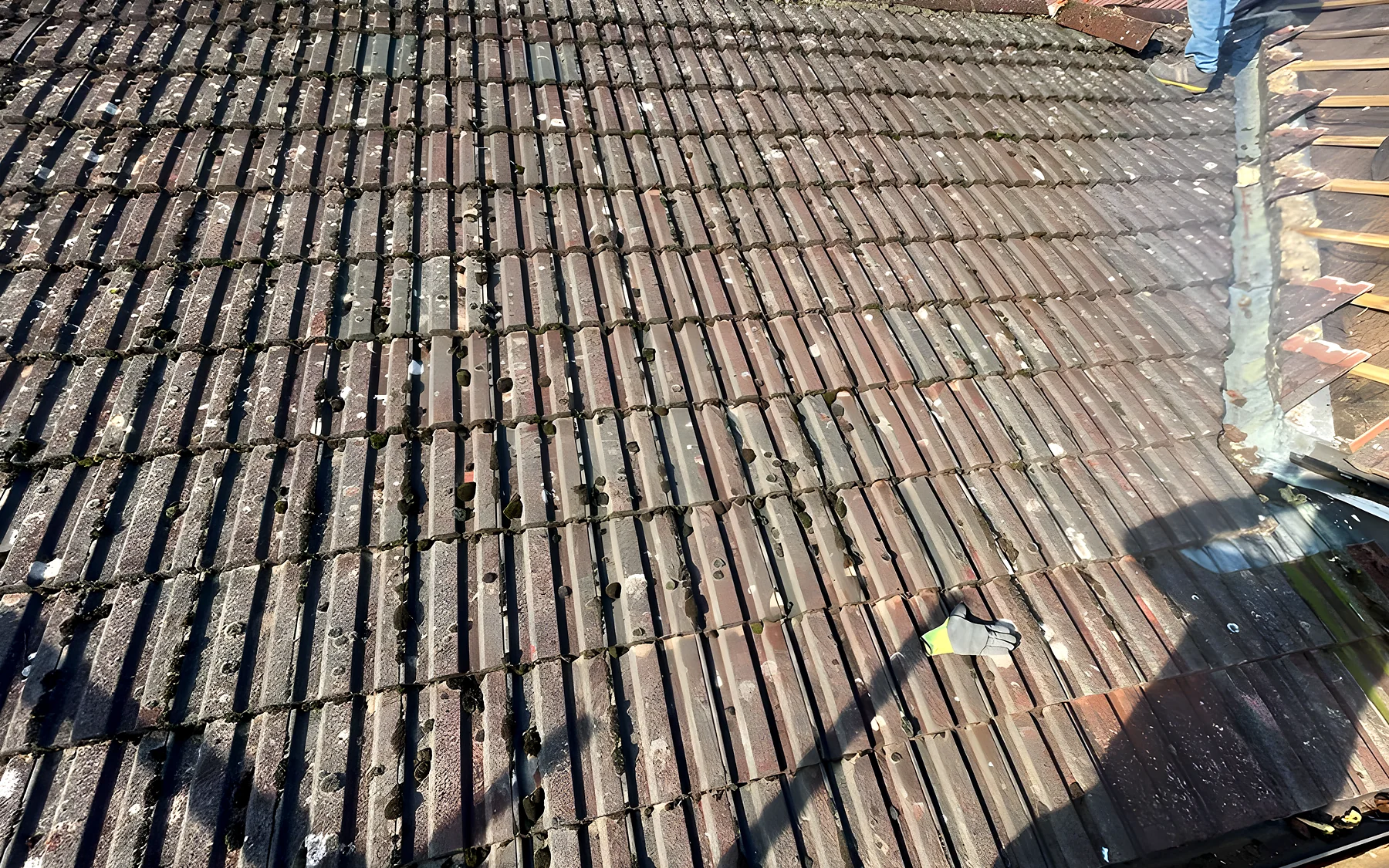 A large re tiled roof with the chimney repointed