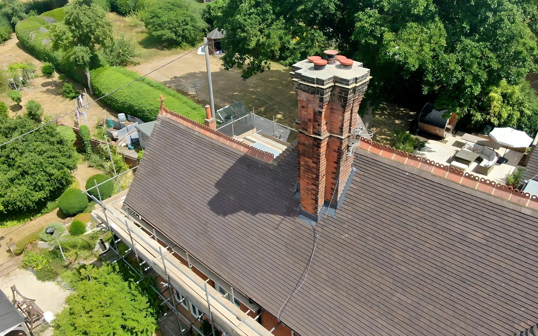 A repointed chimney and new plain tiles on a Victorian house, from the scaffold
