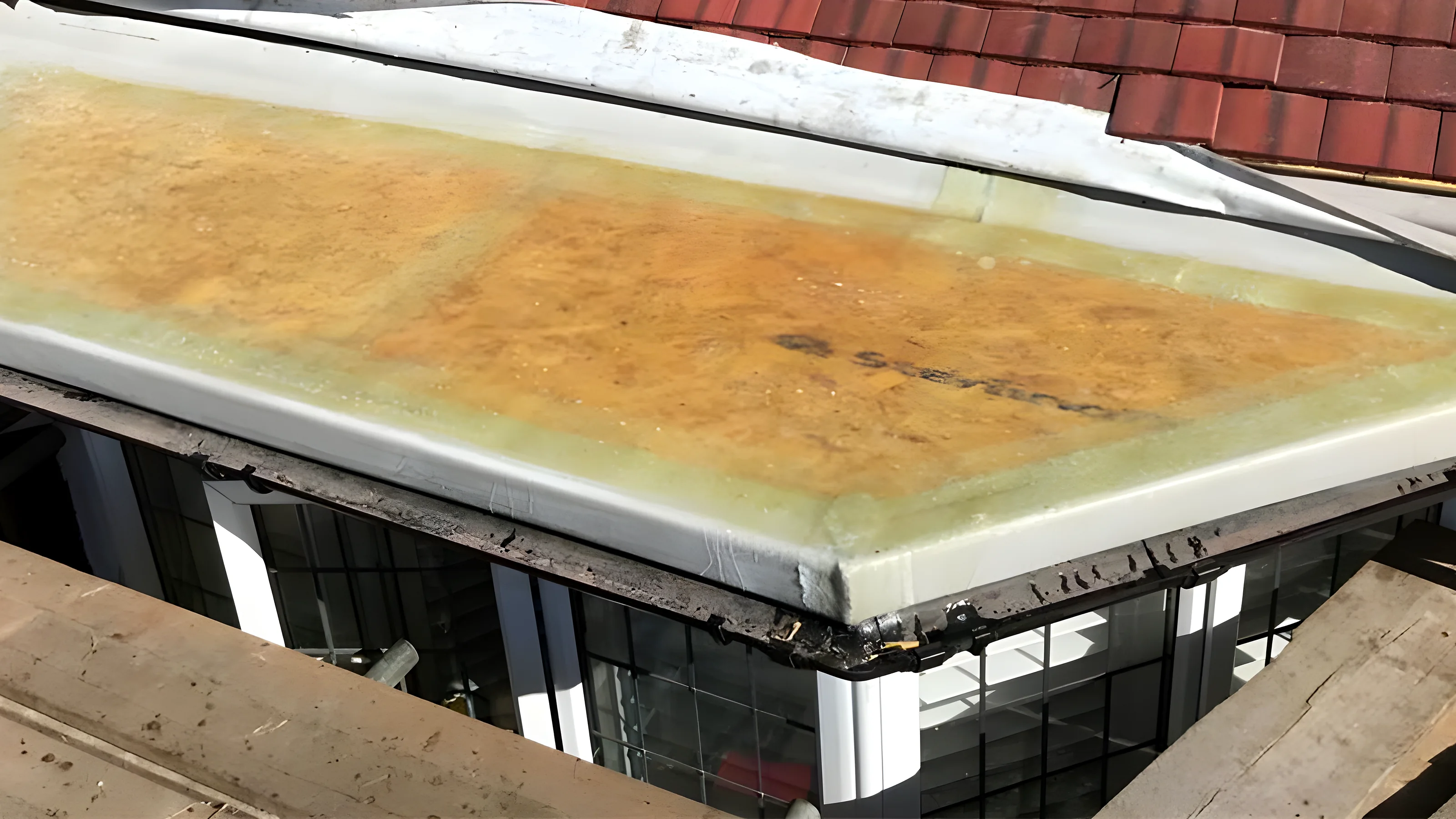 Old felt stripped from a flat roof deck ready for the new covering