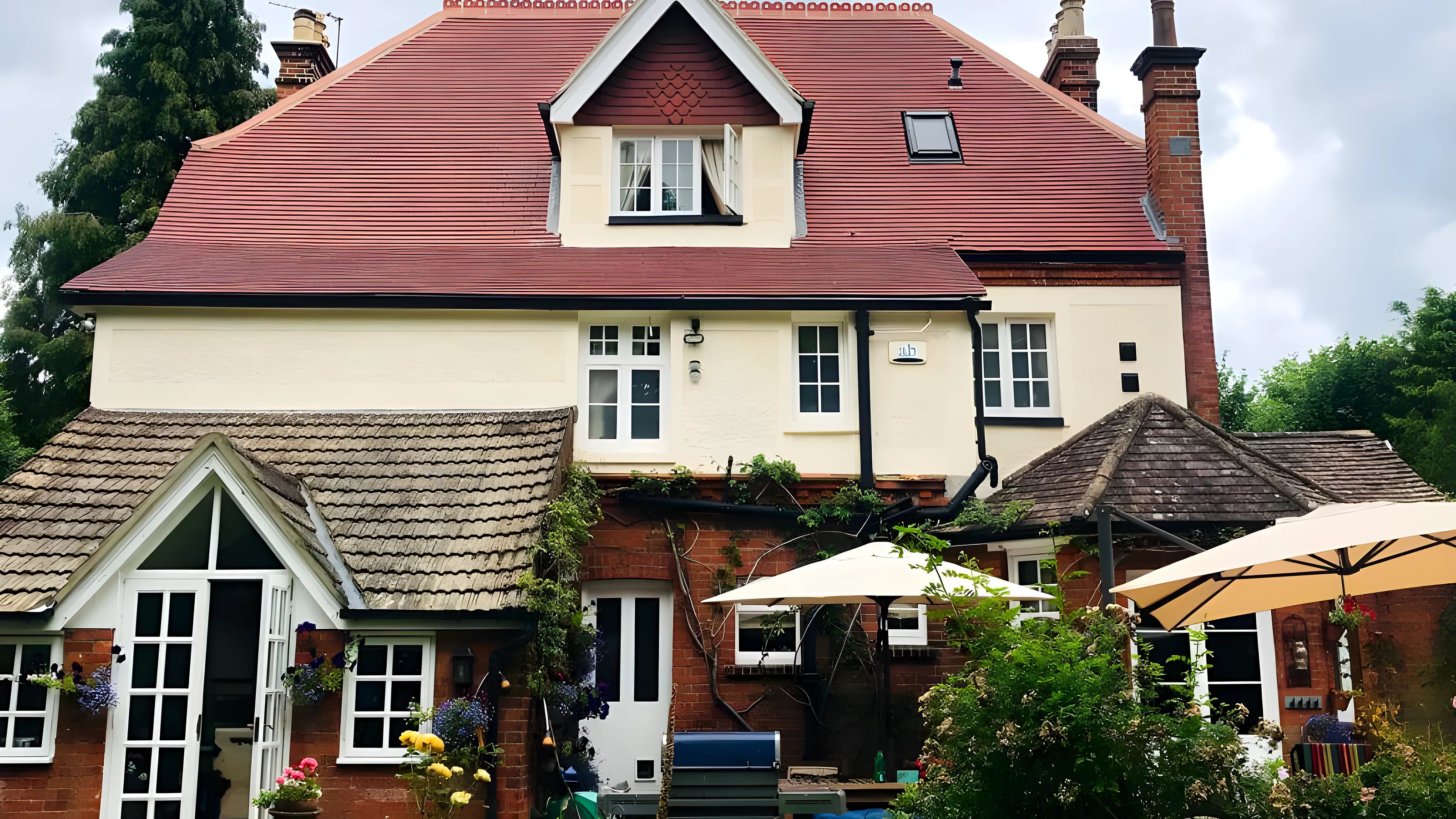 Period house with a new red clay tiled roof, one of our re roofs