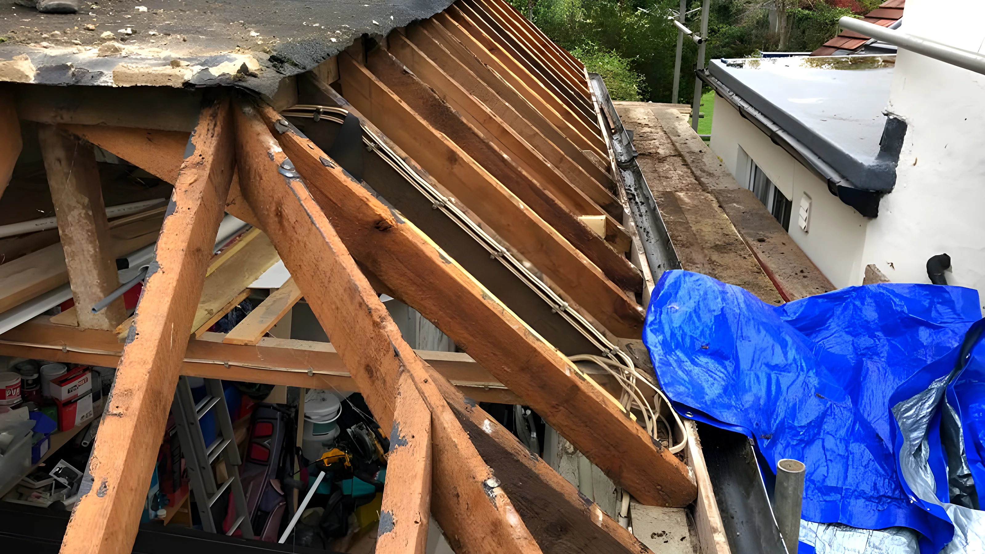 Roof stripped back to the rafters ahead of a repair