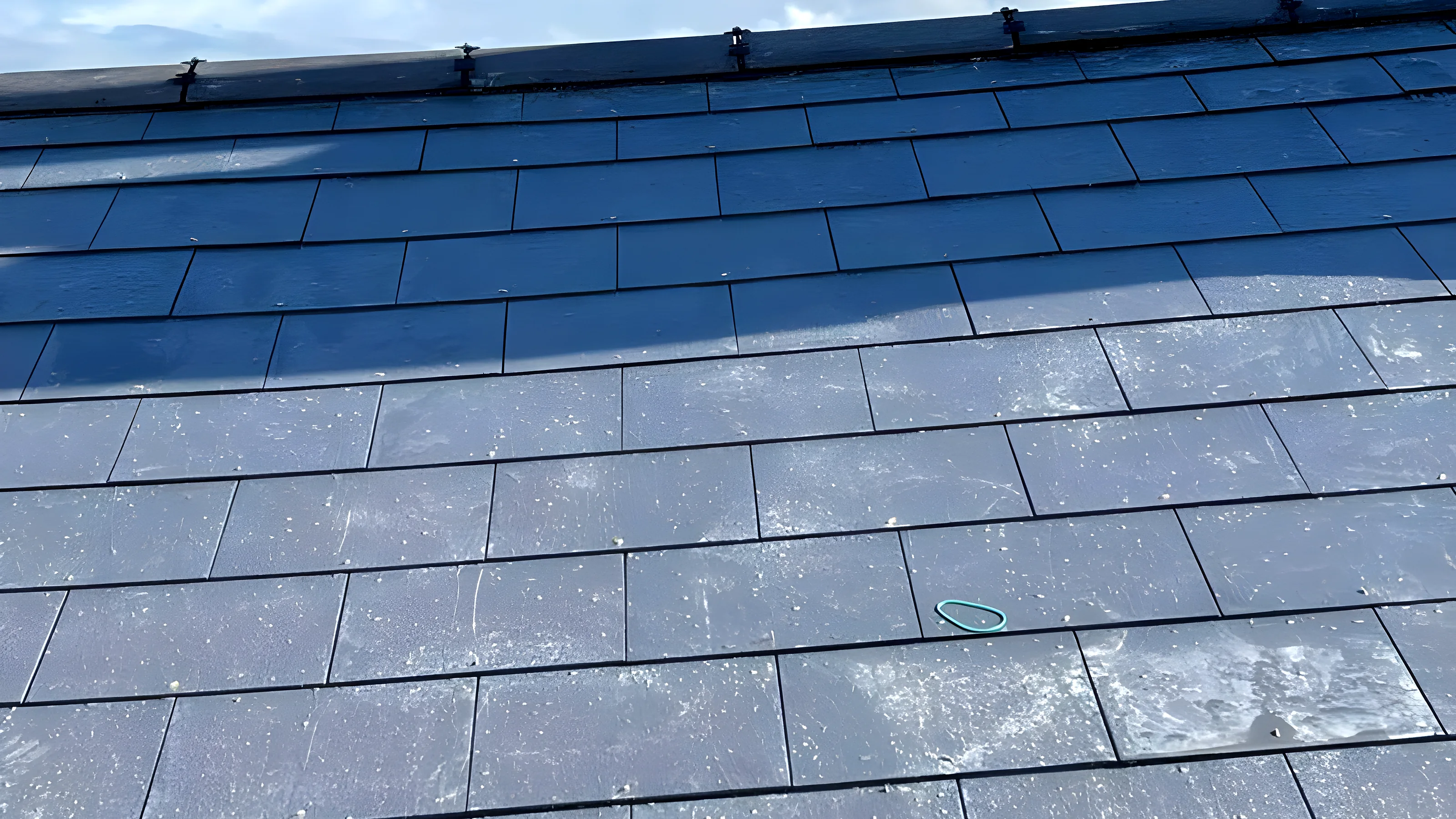 Blue grey slate roof with a lead valley running down the centre