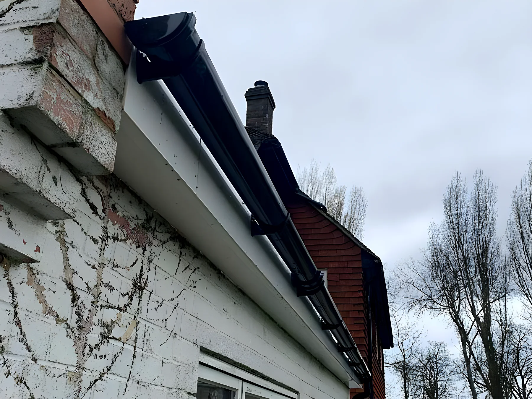 A rotten timber soffit before replacement