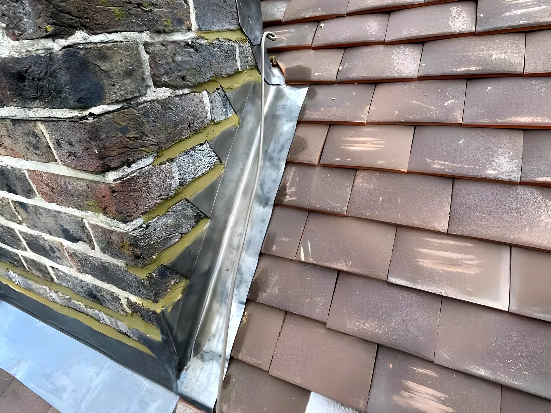 Lead flashing at the base of a chimney