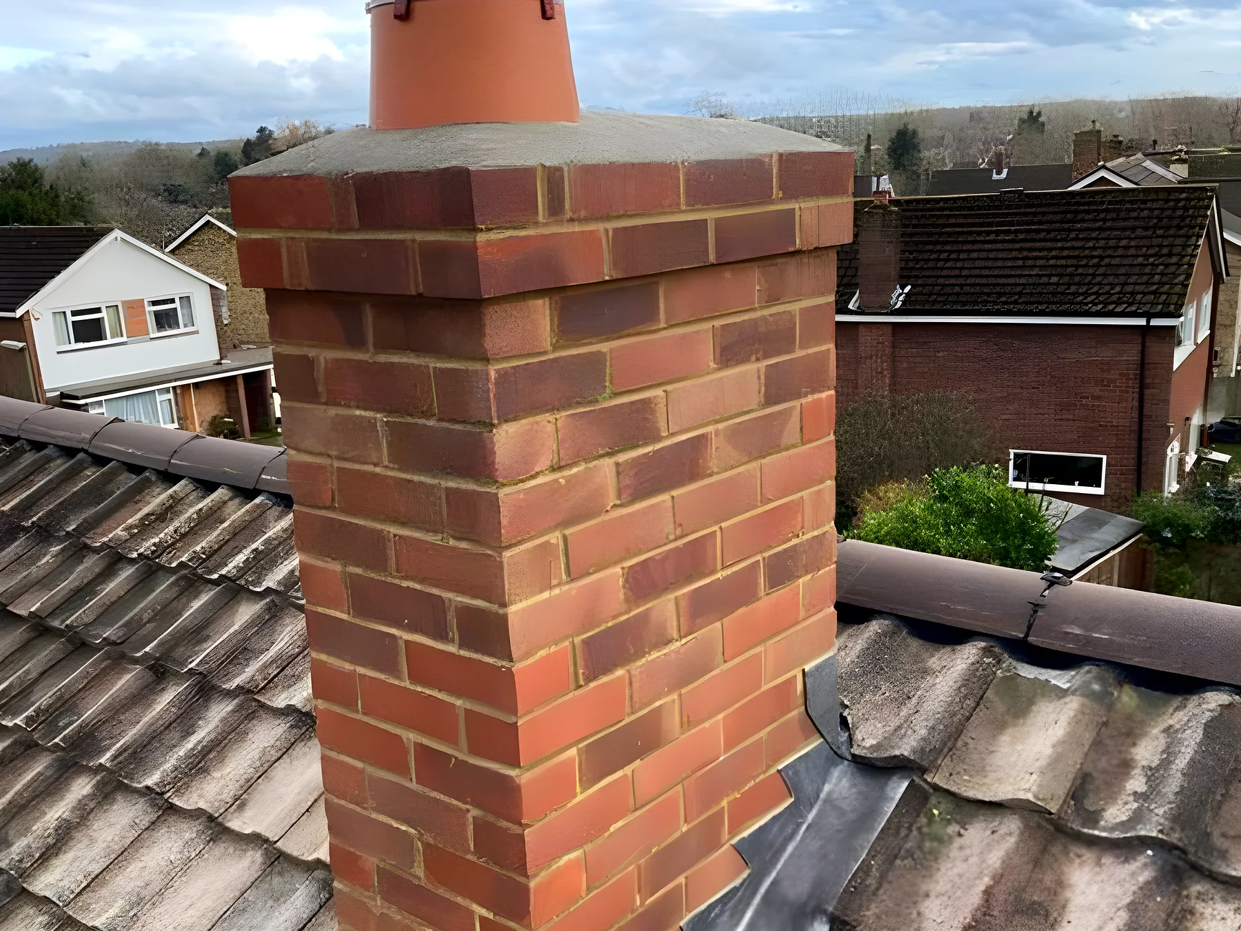 A chimney repointed on a tiled roof