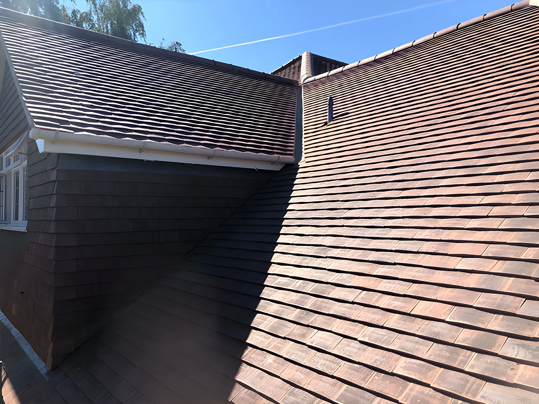 A dormer in brown tiles