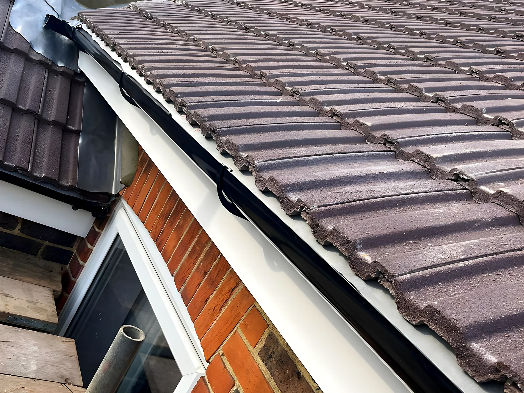 New tiles, fascia and guttering at the corner of a house