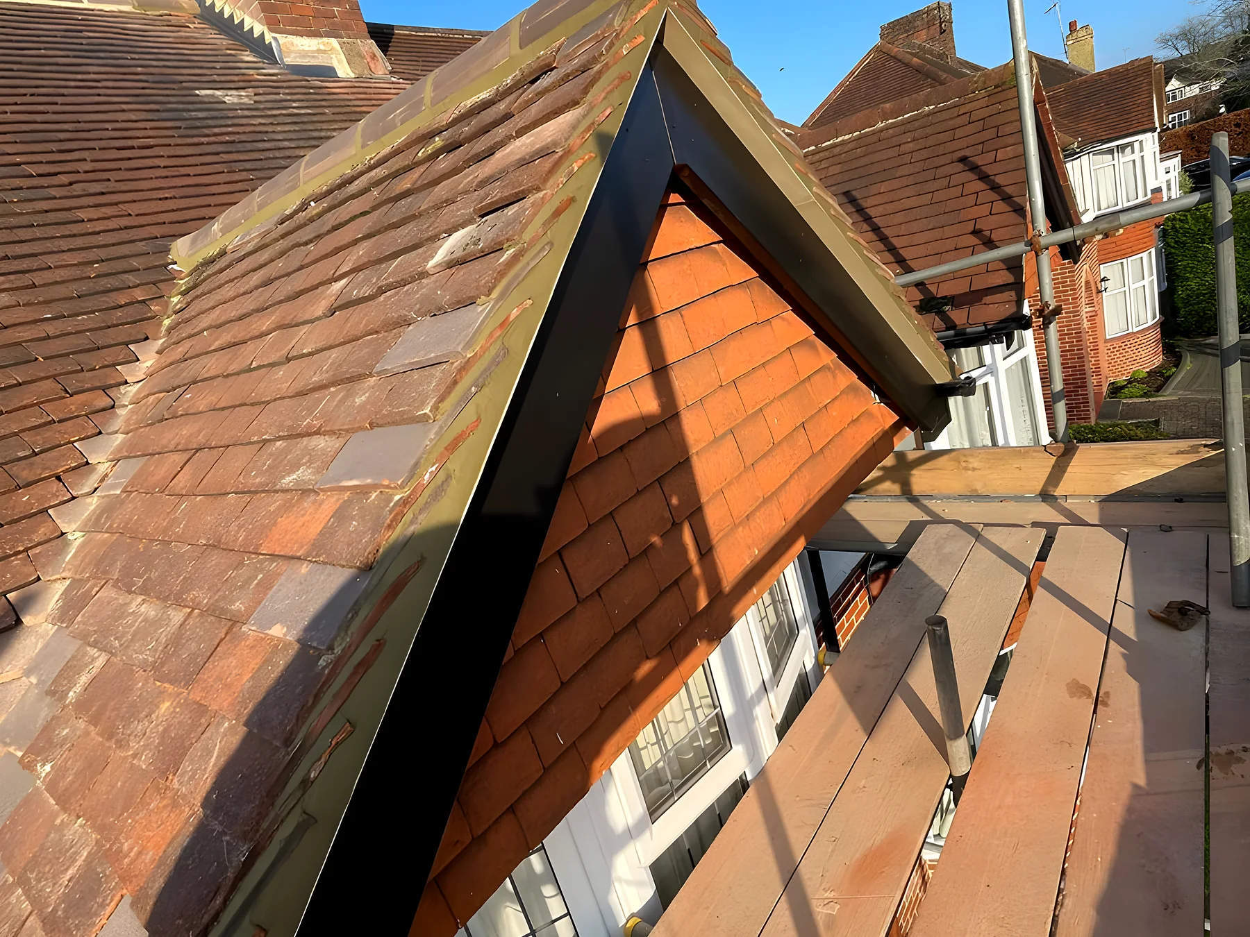 Clay tiles meeting a new lead valley and box gutter