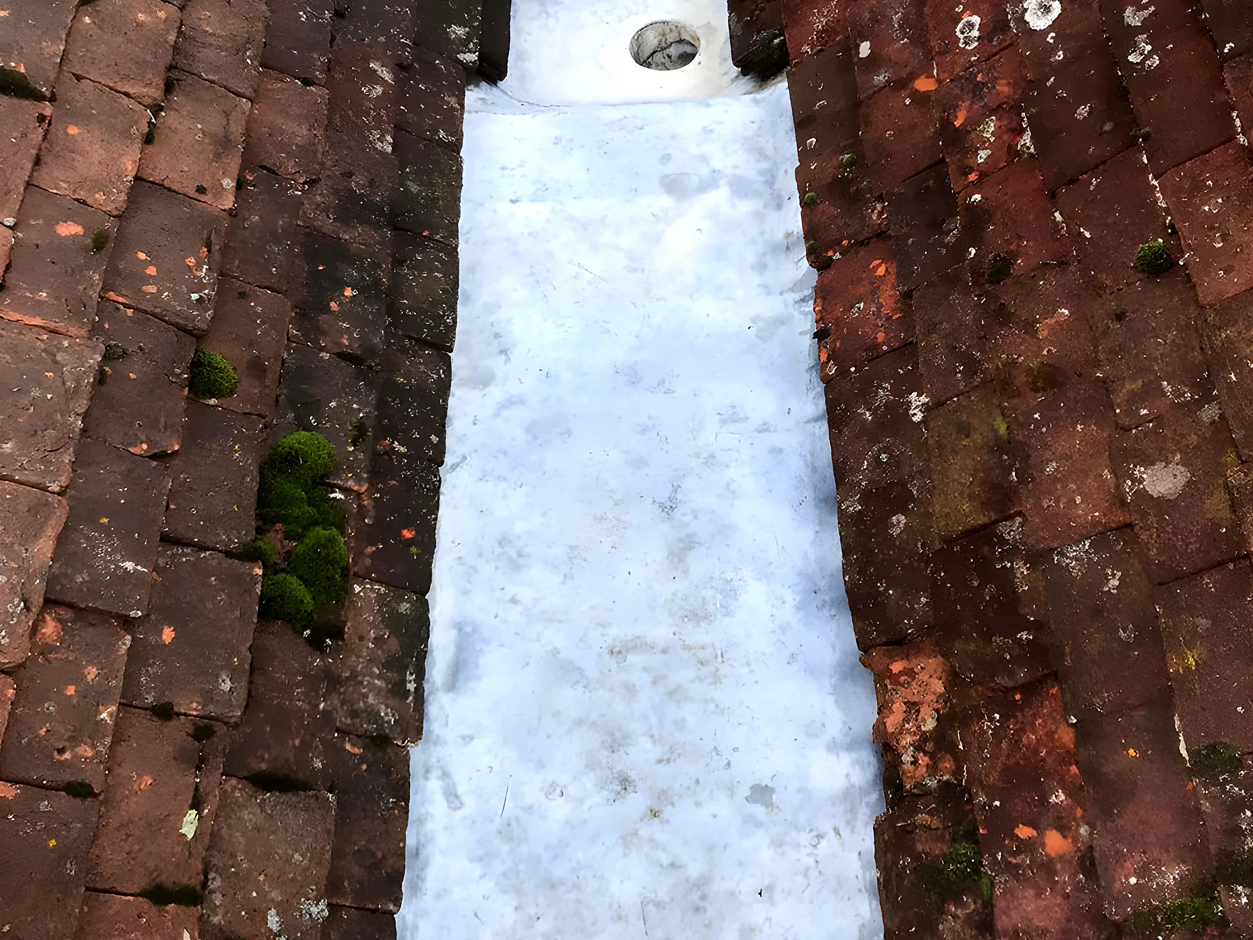 A relined valley gutter between two old tiled slopes