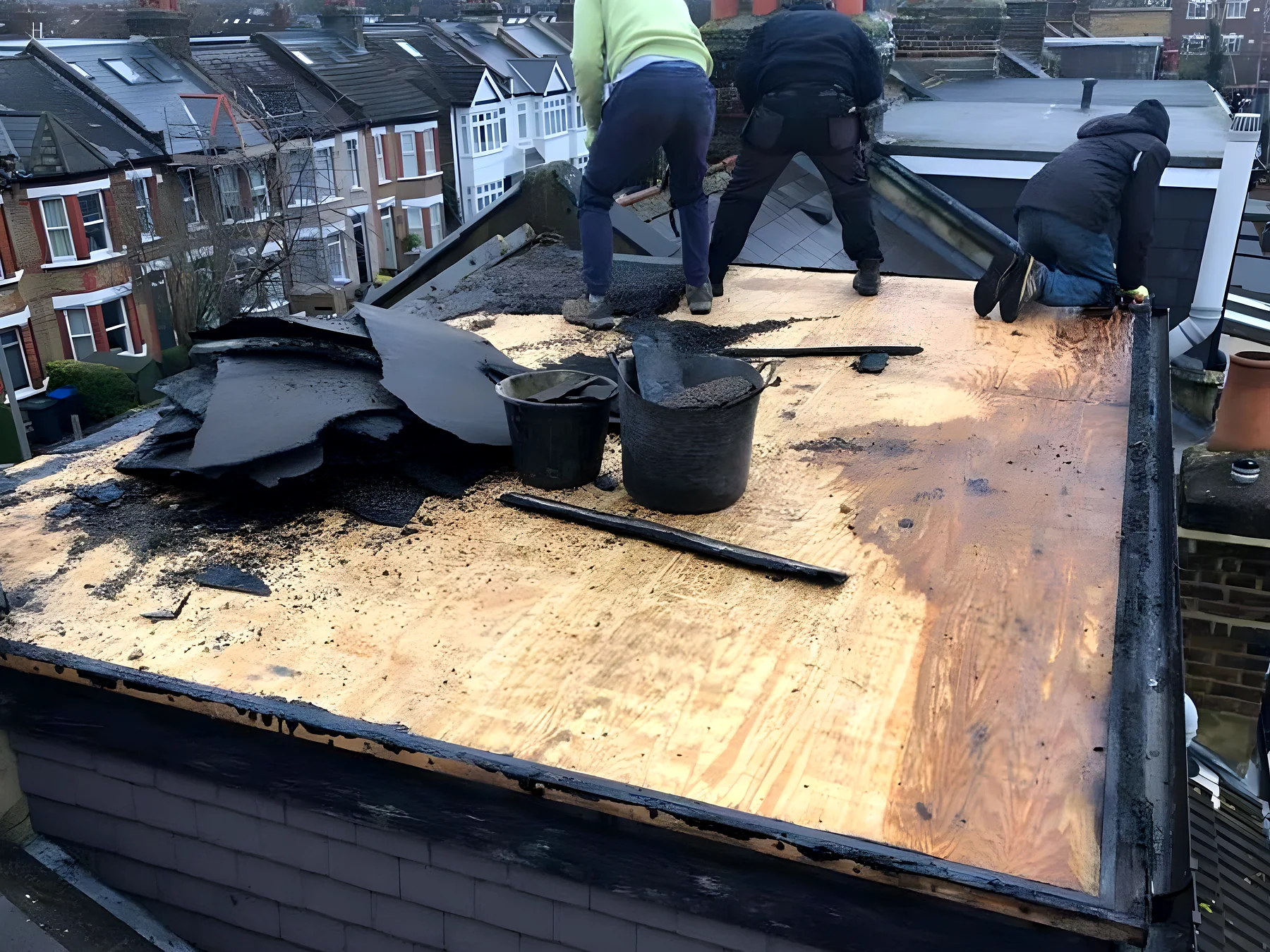 Our roofers laying a new flat roof deck on a terraced house