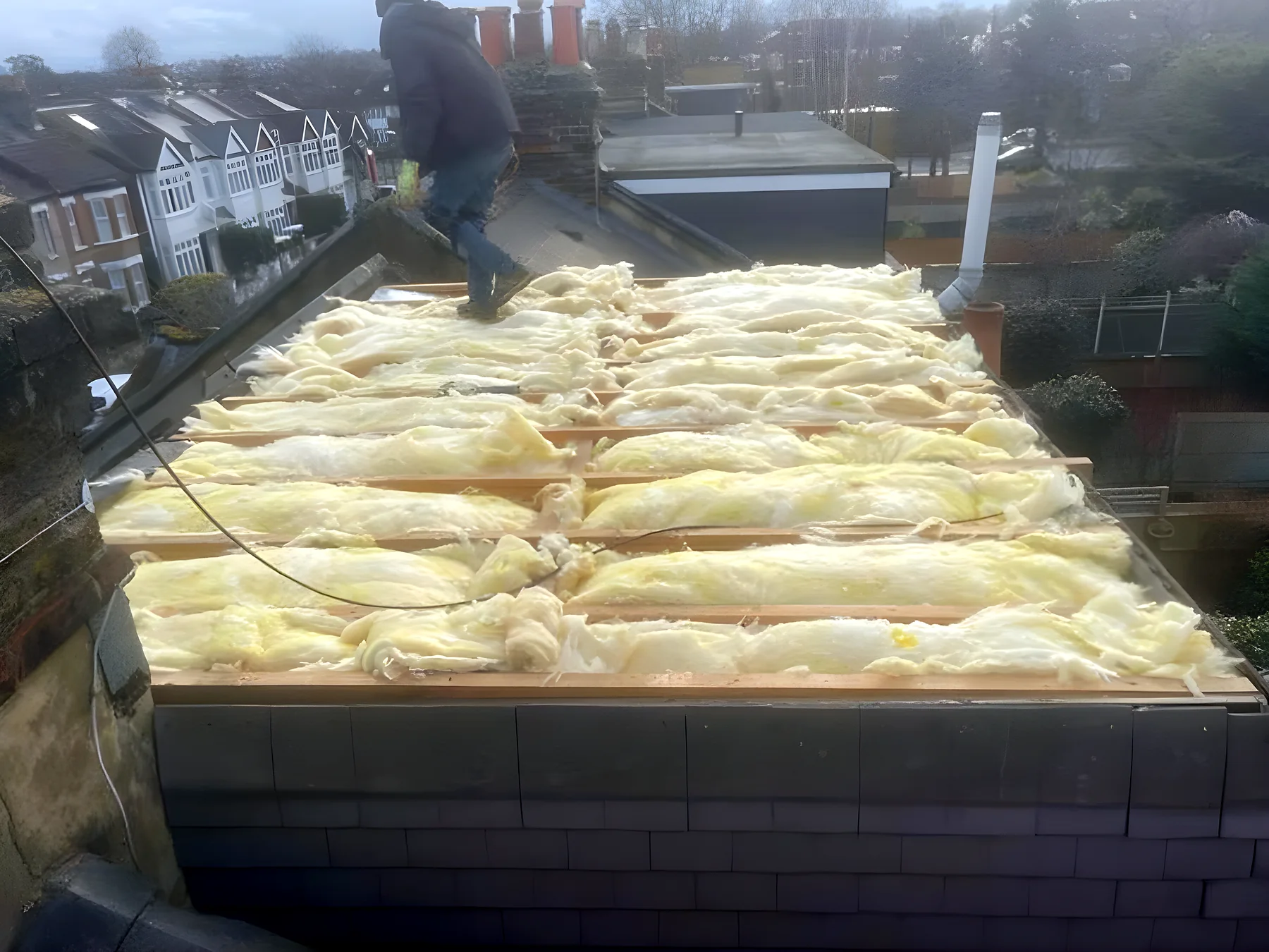 Insulation laid across a flat roof before the deck goes down