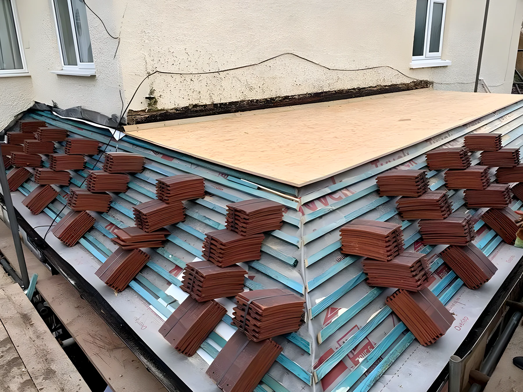Clay tiles loaded out on new battens, ready for laying