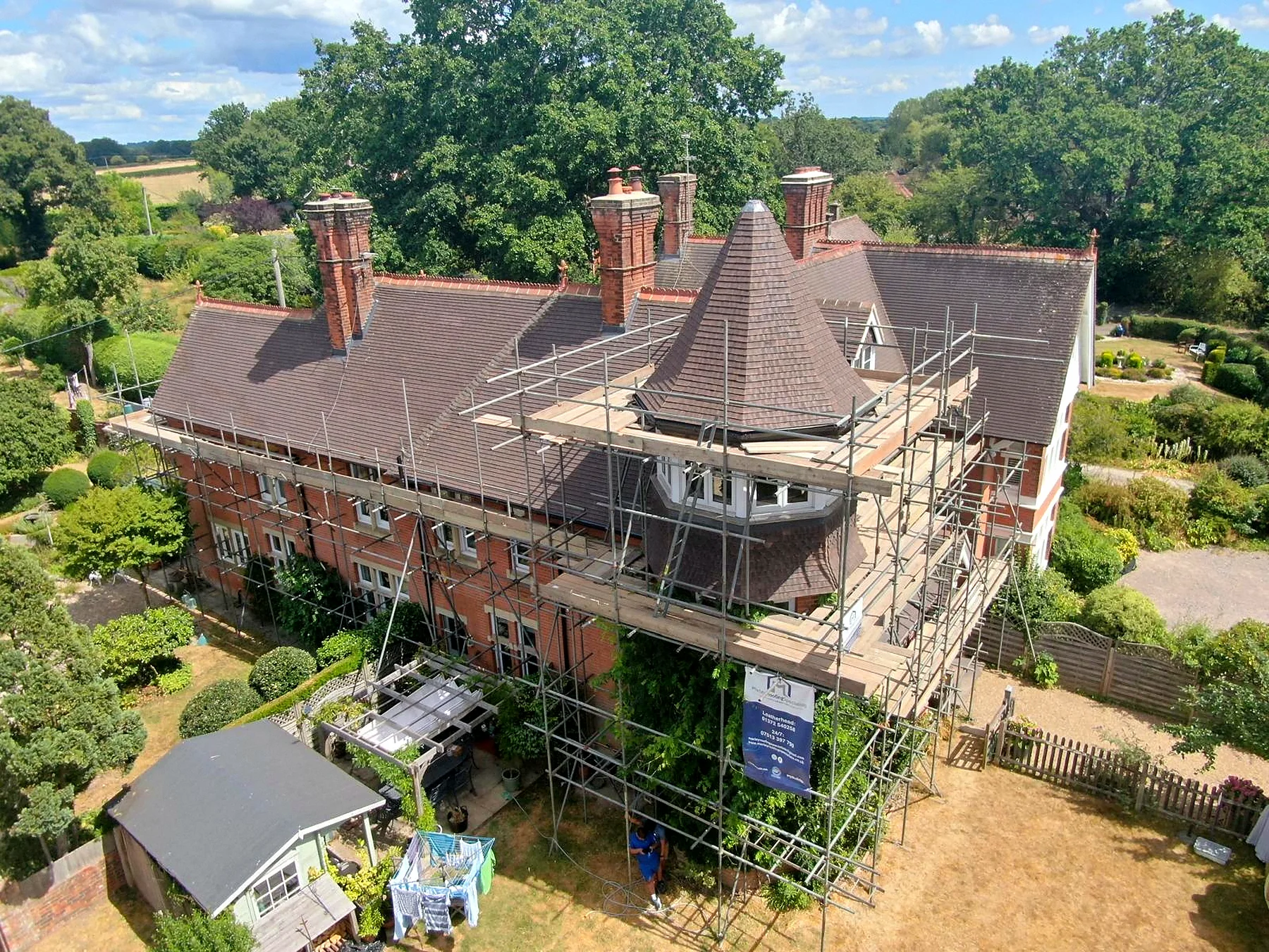 A Victorian house re roofed in plain tiles, the scaffold still up