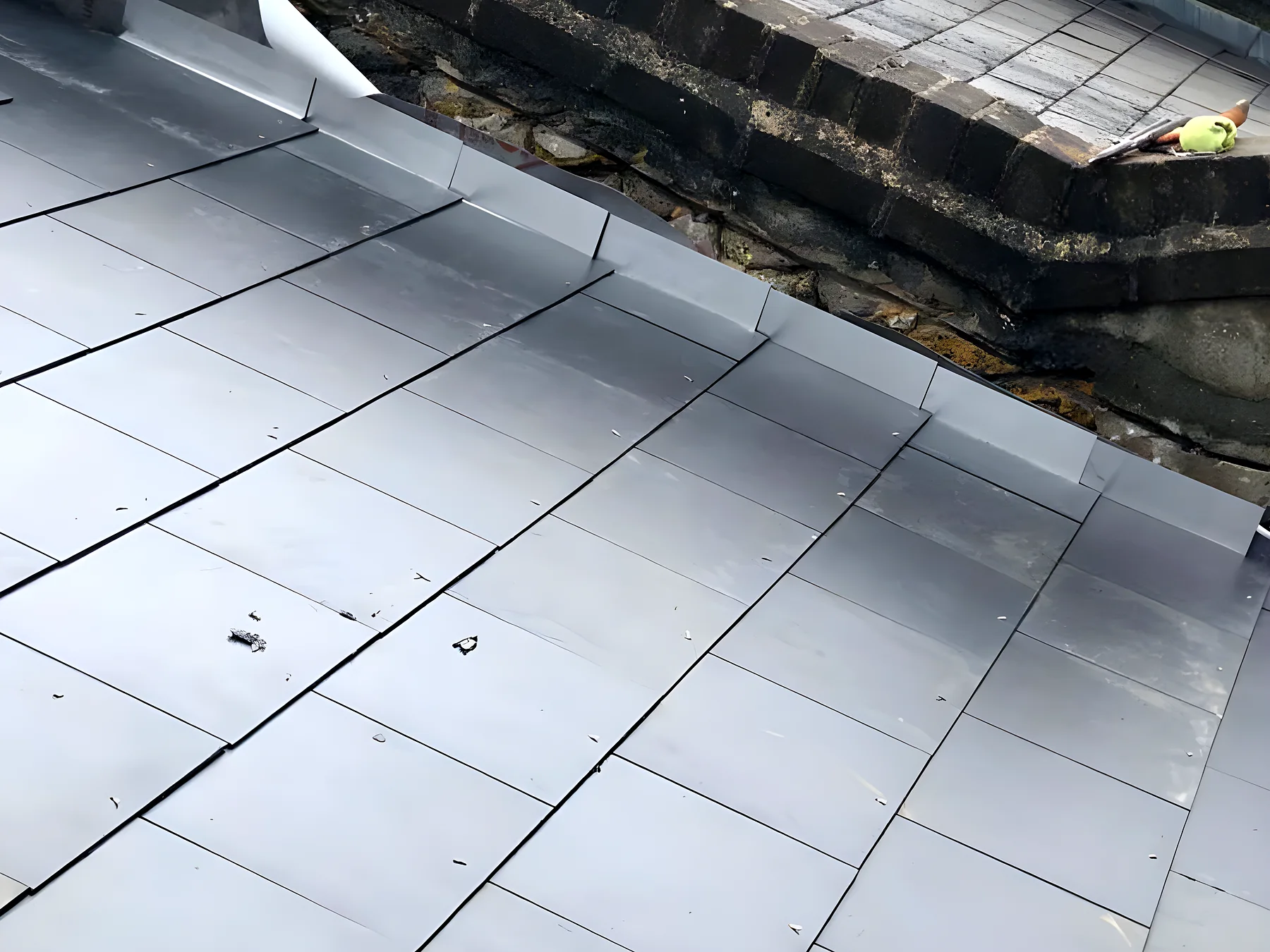 Blue grey slate roof with a lead valley running down the centre