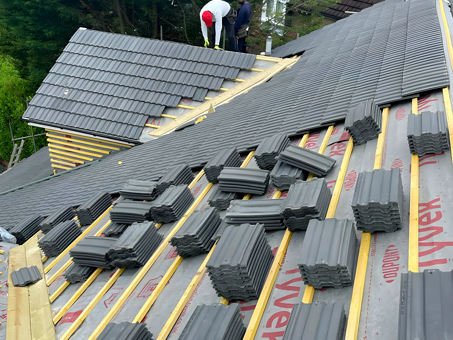 Roof stripped to new battens with tiles loaded out ready to lay