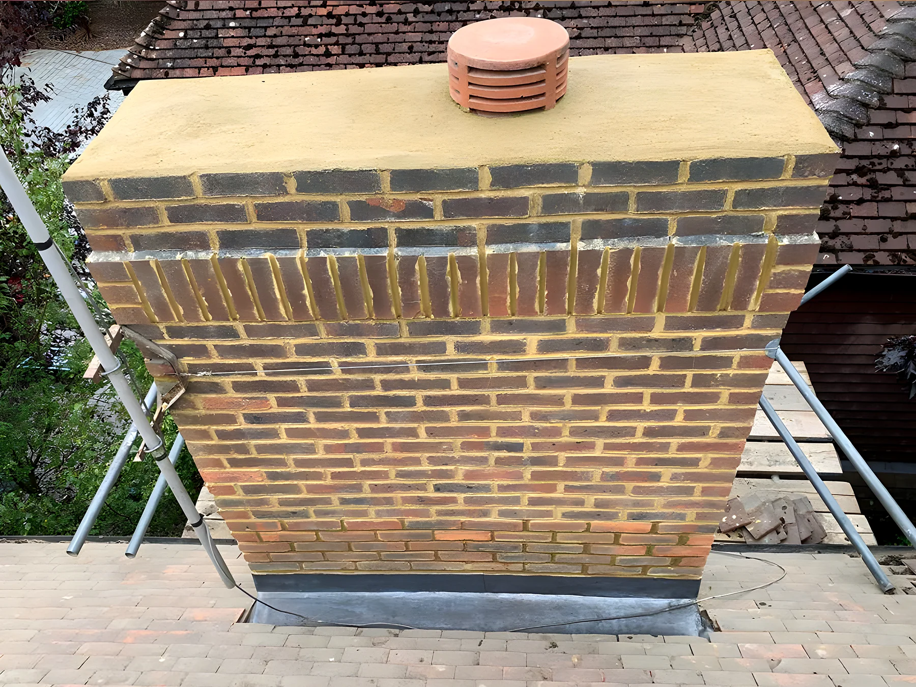 Rebuilt brick chimney with a new lead tray and clay pot