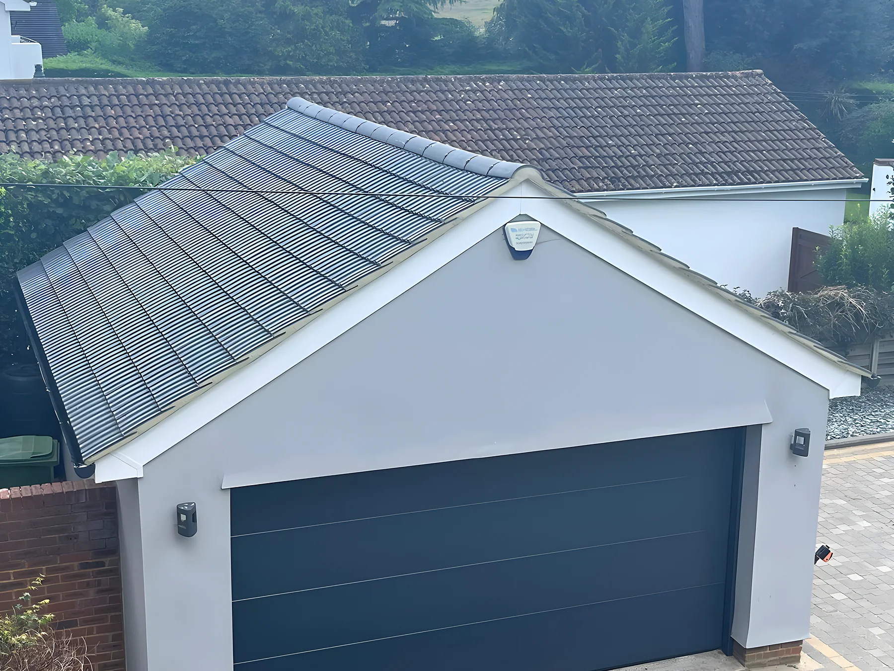 Detached garage with a new grey interlocking tiled roof