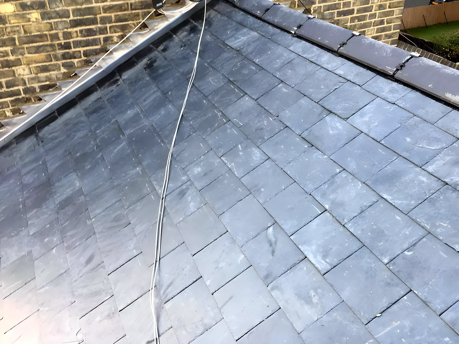 Completed hipped roof in natural slate